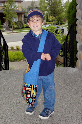 a happy boy and his school bag