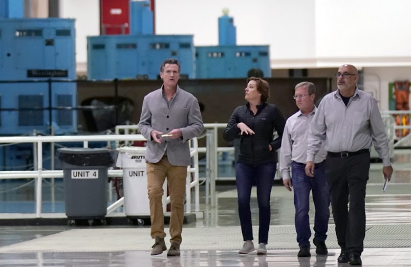 Gov. Gavin Newsom, left, and Department of Water Resources Director Karla Nemeth, second left, tour the Edward Hyatt Power Plant at the Oroville Dam in Oroville, Calif., Tuesday, April 19, 2022. California energy authorities predicted that the state would face an energy shortage this summer on Friday, May 6, 2022. Newsom took a tour of the hydropower plant and spoke about how the drought is affecting power generation.