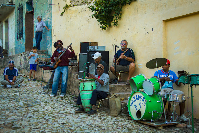 Cuban musician playing in a typical cobblestone road in Trinidad