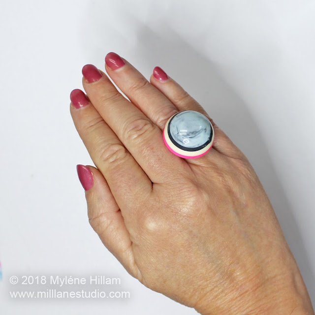 Pink and Grey Striped bubble ring worn on the ring finger