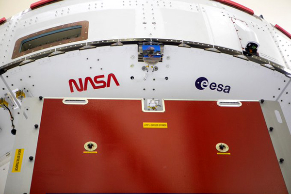 The NASA 'worm' and ESA (European Space Agency) logo are visible below the Crew Module Adapter of the Orion capsule that will launch on Artemis 1 next year.