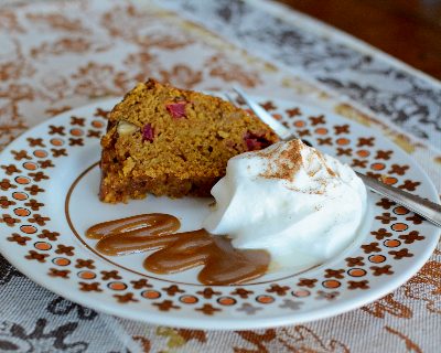 Thanksgiving Cake plated with caramel sauce, whipped cream ♥ KitchenParade.com, one cake, all our favorite fall flavors, pumpkin, apple, cranberry, pecans, warm spices.