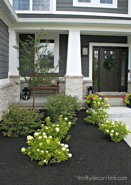 Dark house with white trim and craftsman columns