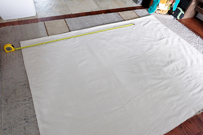 laying out canvas drop cloth to trim