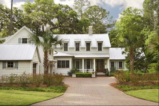metal roof and gray shutters white siding 