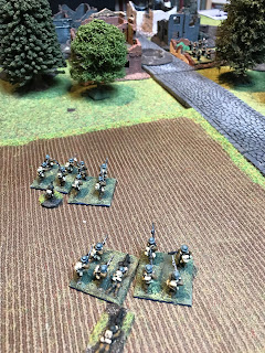 The British Lewis gun and rifle grenadiers take up position on the left flank of the hamlet