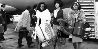 The Supremes arriving to a tour stop clad in fur.