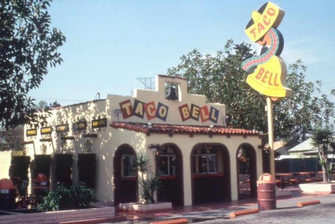 Glen Bell daily watched the long lines of customers at the Mexican restaurant, located directly across from the booth where hot dogs were sold.