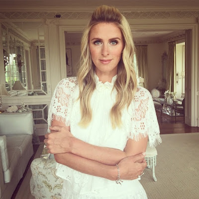 Nicky Hilton is a happy pose to the camera