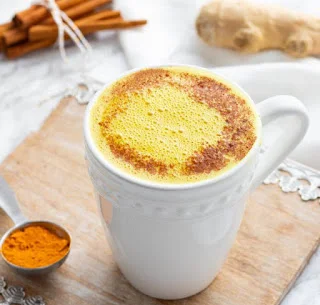 Mug of turmeric gold milk showcasing the benefits of milk and tumeric for health and wellness