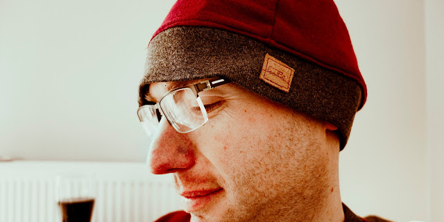 Graham wearing his beanie hat. There is a small leather label on the cuff with a truck stitch on it.