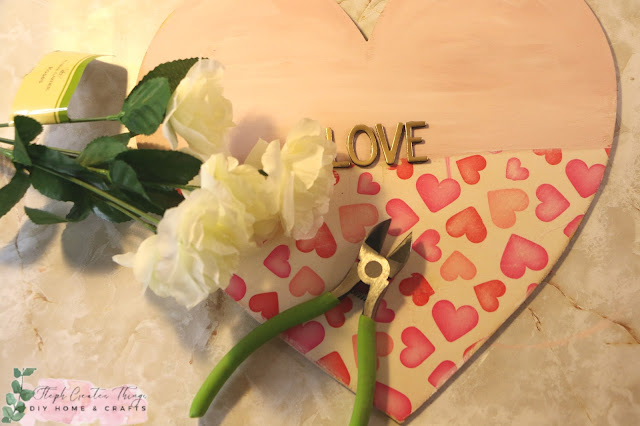 Faux white flowers, floral cutters and painted wooden heart