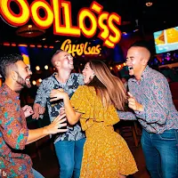 A group of friends laughing and dancing at Ojos Locos Sports Cantina y Casino