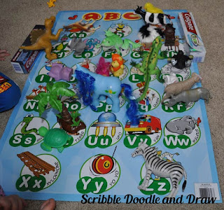 Learn beginning letter sounds with toy animals and an abc poster