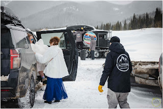 bride getting out of car for waiting snowcat
