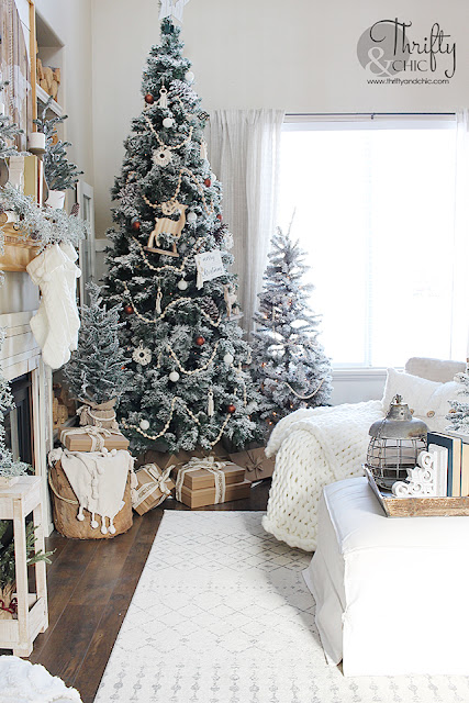 Neutral Christmas living room decor. Wood and white Christmas decor. Boho style Christmas decor. Bohemian style Christmas tree. Beaded and macrame Christmas tree decor and decorating ideas. How to decorate a Christmas tree. Farmhouse style Christmas decor. Wood and White Christmas mantel decor. Vintage Christmas mantel ideas. Flocked Christmas trees. Two story living room design.