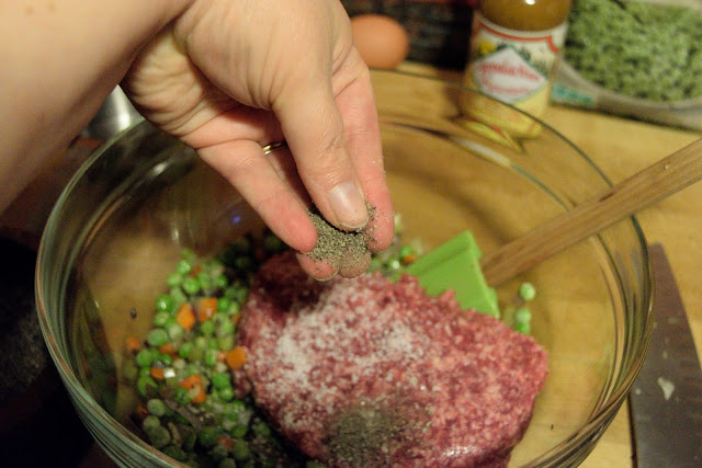 Pepper being added to the ground beef.