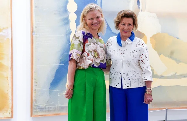 Queen Sonja wore a royal blue jumpsuit and white lace top. Hans Rasmus Astrup. Astrup Fearnley Collection