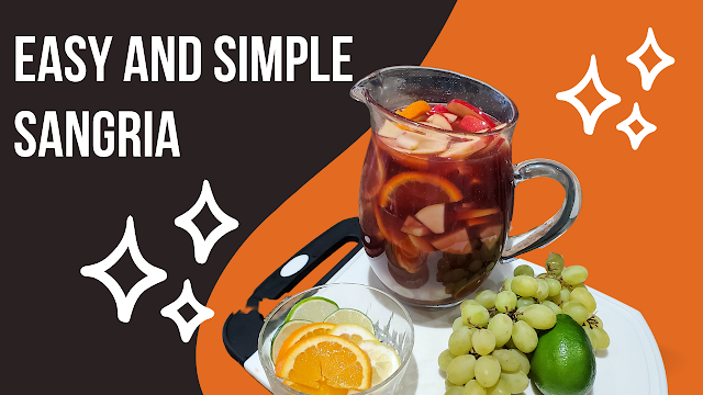 A pitcher of red wine sangria with a bowl of fruit.