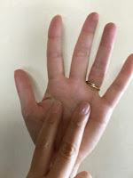 An open palm with two fingers from the other hand signifies seven in Japan