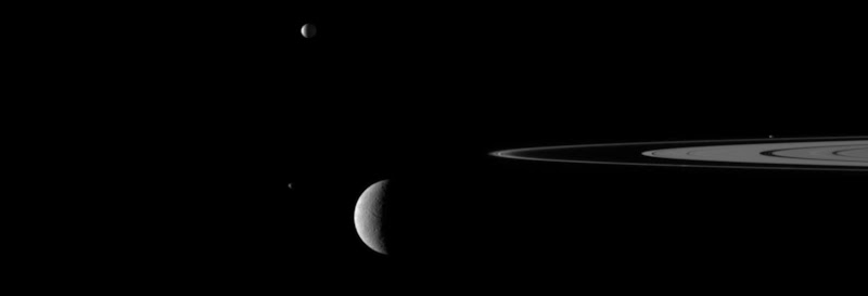 Saturn's rings and moons: Rhea and Janus (lower left) Mimas (center top).