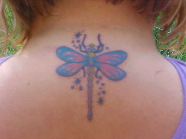 Flying fairy and dragonfly tattoo on the arm.