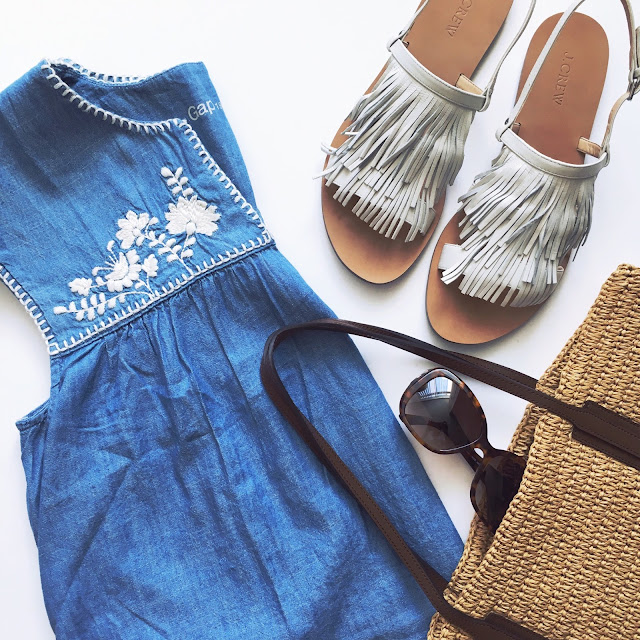 Embroidered chambray top, white leather fringe sandals, Versace sunglasses and straw tote bag