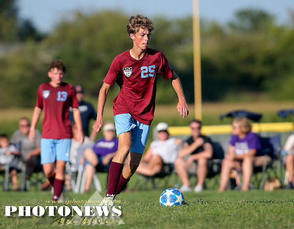 Aiden Cromwell dribbles the ball down the soccer field