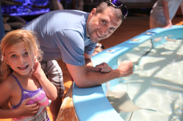 Father and daughter enjoy the touch tanks at the Marine Science Center in Daytona