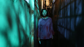 asian woman walking down an alley