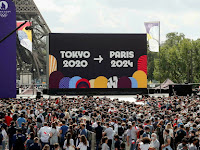 Olympic flag passed to Paris Mayor for 2024 Games.