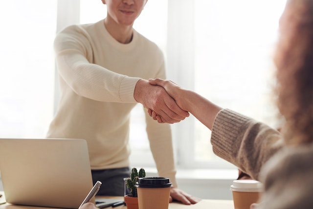 Persons shaking hands.