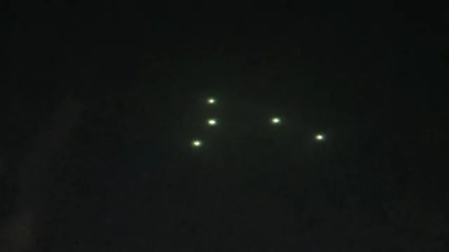 2 of the green UFO Orbs are flying away from the UFO formation of 5 UFOs Texas.