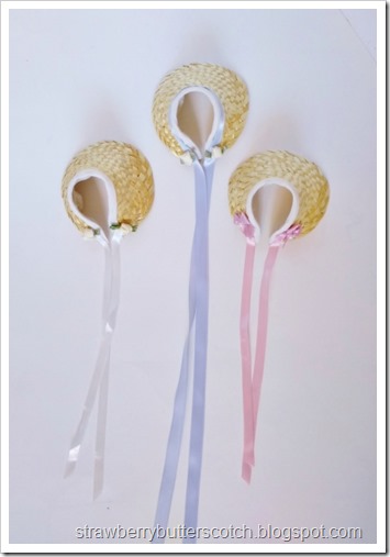 Three doll sized half bonnets made from craft store straw hat with ribbon, bows, and flowers.