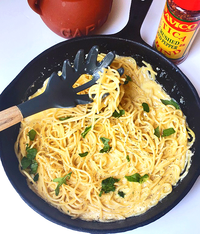 pasta with cream sauce in a cast iron skillet