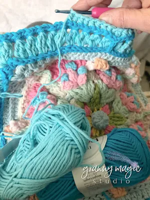 Crocheting a square border around a circle.