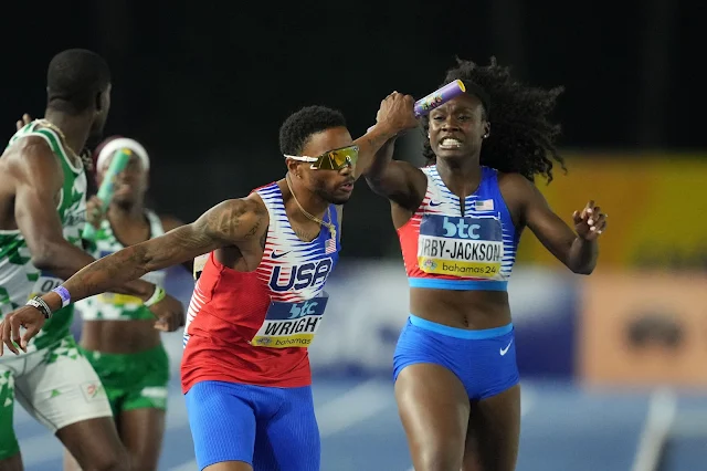 May 5, 2024; Nassau, Bahamas; Willington Wright takes the handoff from Lynna Irby-Jackson on the third leg of the USA mixed 4 x 400m relay that won in a championship record 3:10.73 during the World Athletics Relays at Thomas A. Robinson National Stadium. Mandatory Credit: Kirby Lee-USA TODAY Sports  Kirby Lee