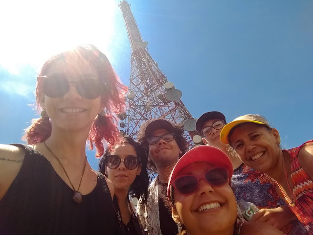 imagem de um grupo de pessoas com a torre do pico do jaraguá