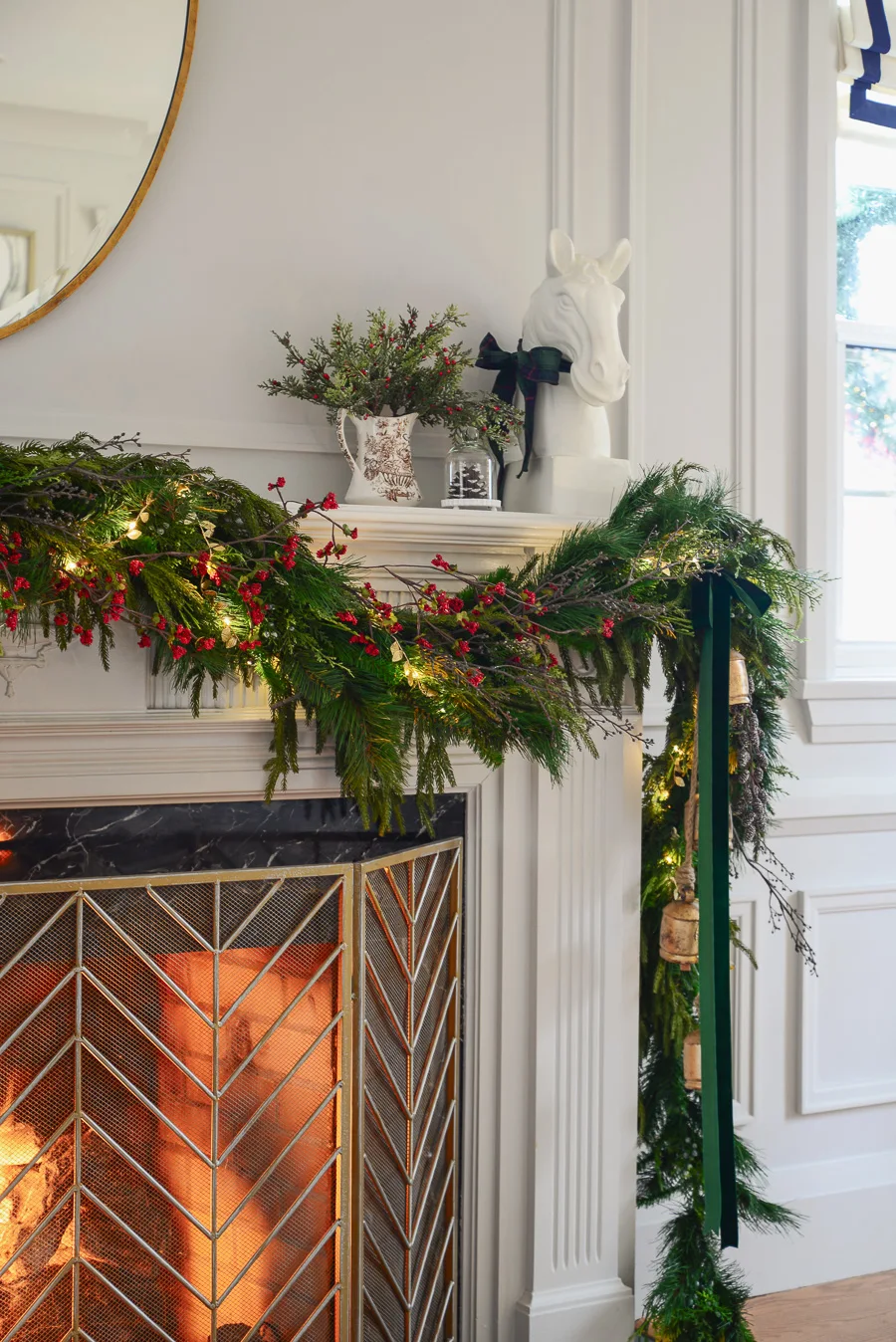 traditional christmas mantel decor with faux garland, mirror, berry vine garland