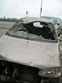 smashed car on side of road