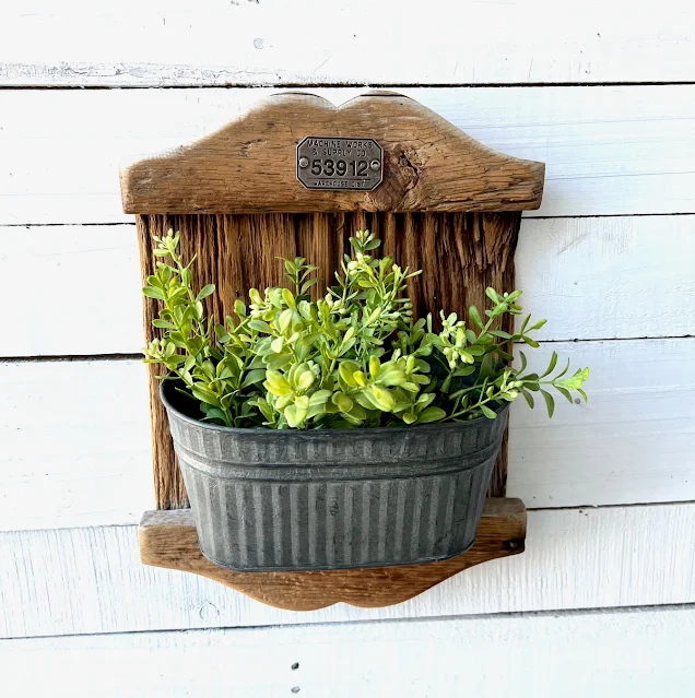 Photo of a repurposed, rustic wall pocket planter.