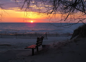 sunset over Lake Michigan with bench