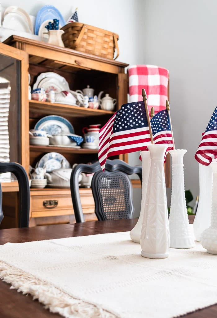 mini flags in milk glass vases