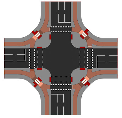 A crossroads junction with grey footways, red cycleways and then a black carriageway. There is a pedestrian island at each corner of the junction with a mini-zebra crossing over the cycle track to get to the corner islands. The cycle crossings of the side roads are outside of the pedestrian crossings.