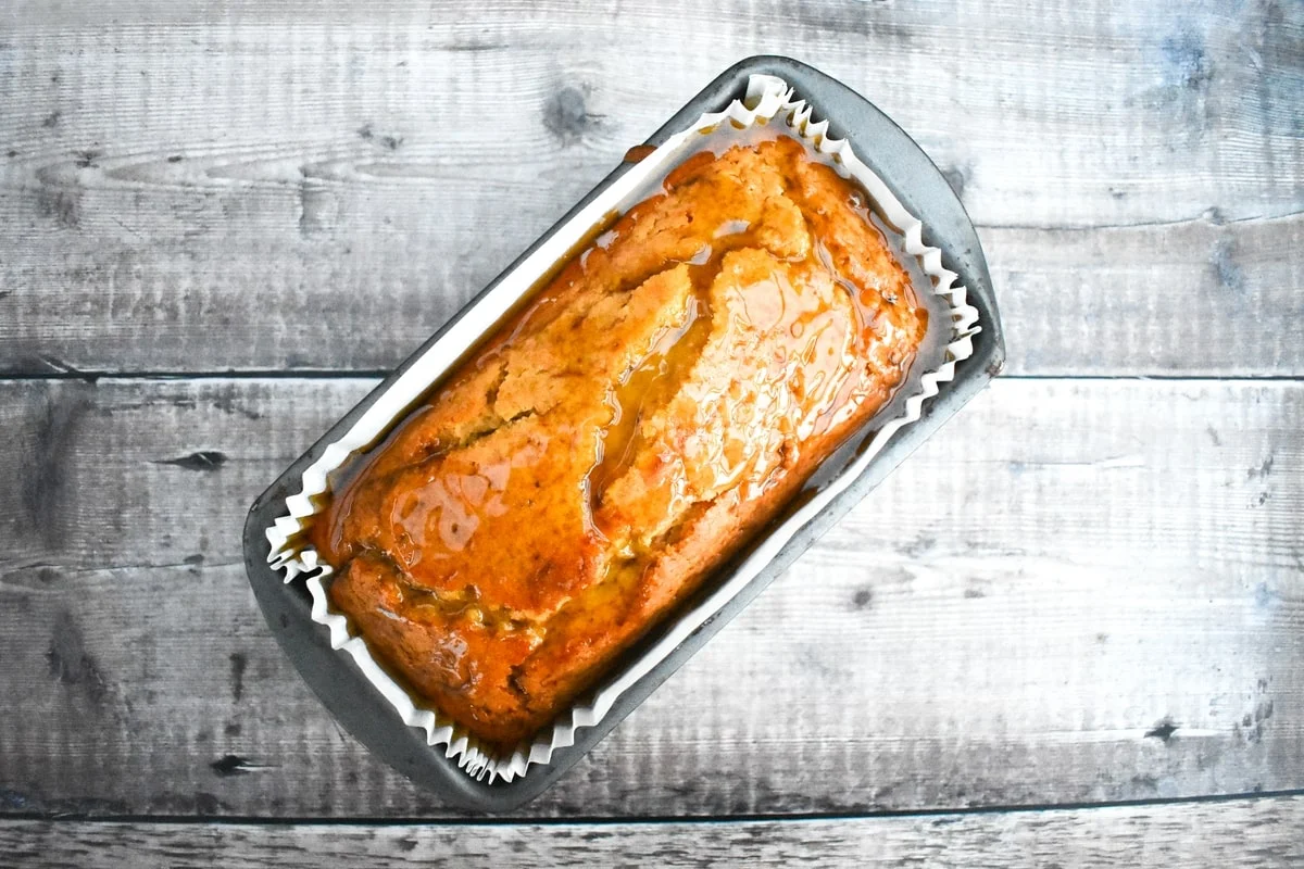 golden syrup loaf cake topped with a sticky golden syrup coating