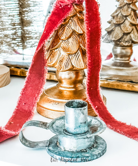 pressed tin candlestick on Christmas mantel