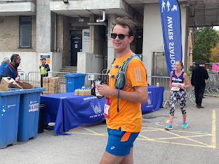 John standing in the finishers area, about to get a medal.