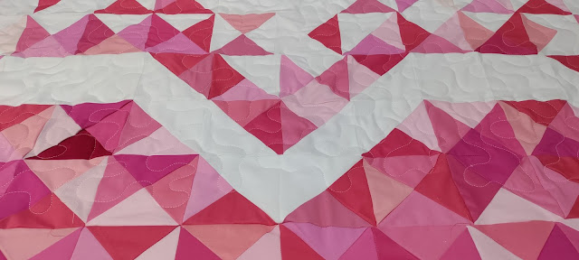 Meander quilting on an Exploding Heart quilt