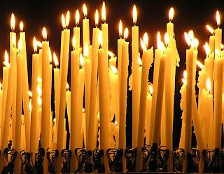 many candles burning in the darkness and making it light