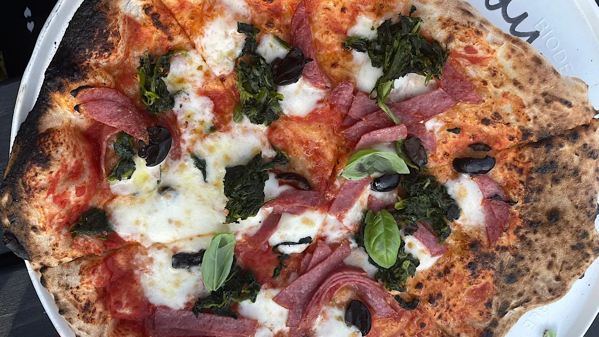 Salami, olives, buffalo mozzarella and basil on an Alkham Valley Pizza | Westwell Wines, Kent